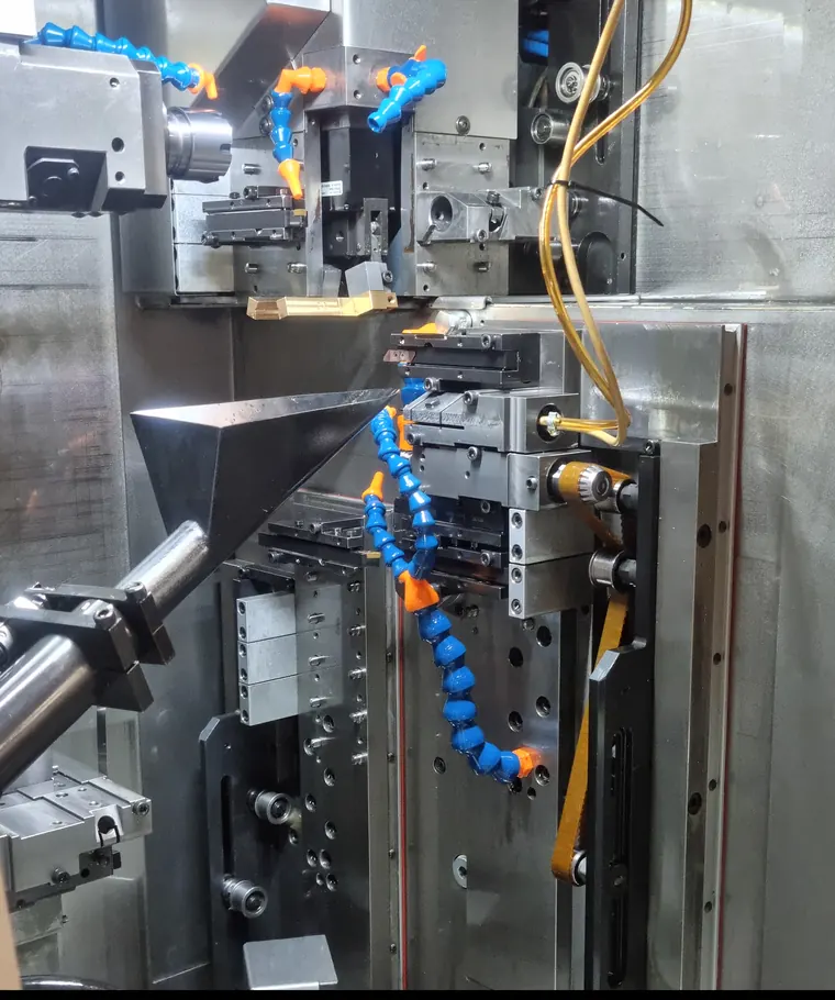 Machining area of a Tornos DECO Swiss-type lathe: tool gang and coolant nozzles
